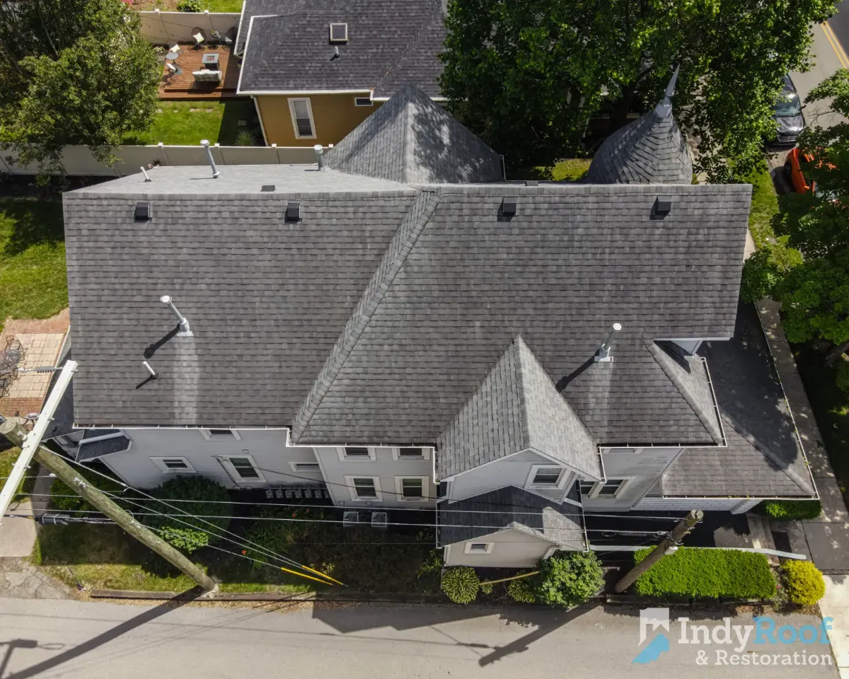 Architectural shingles with ridge vent before restoration in Carmel, IN